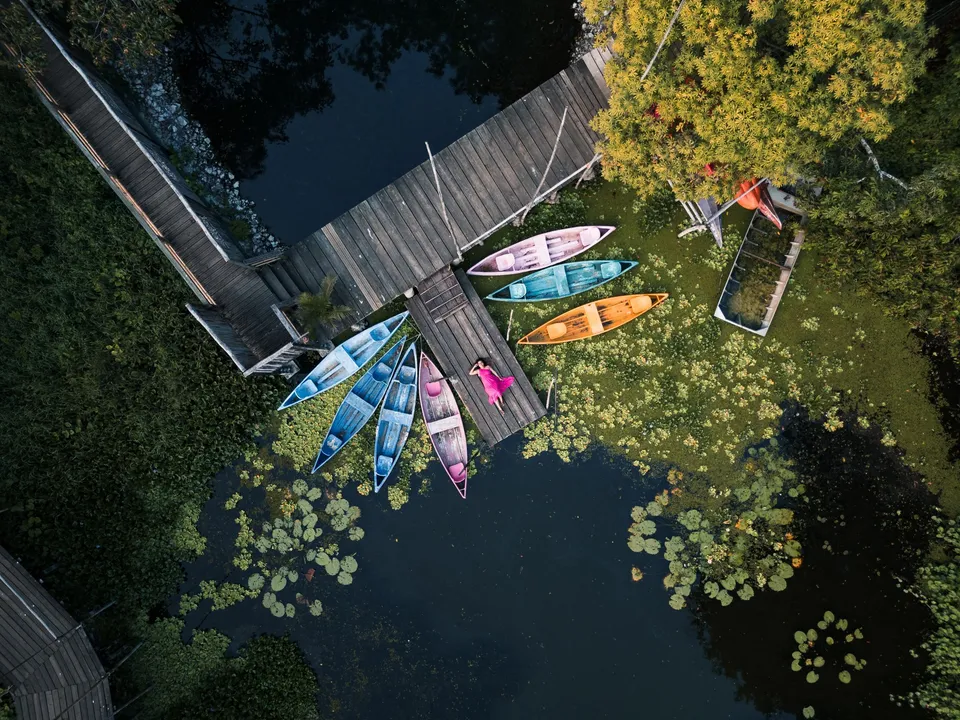 Canoes at the jetty among the water lilies, seen from above
