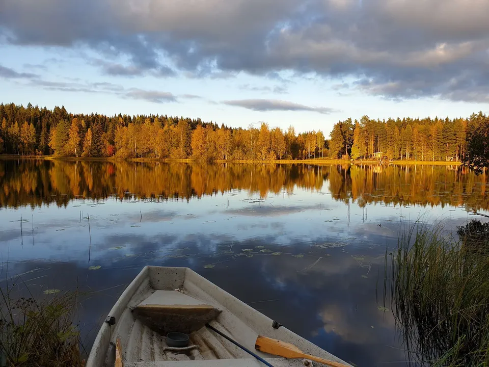 Rowing boat on an autumn lake in evening light