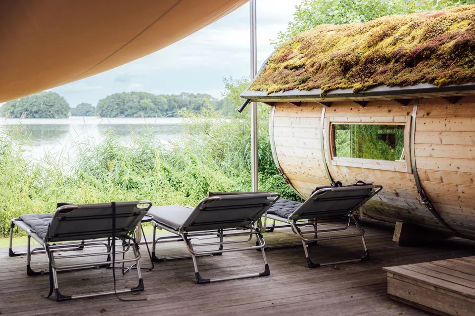 Sauna with sun loungers by the lake